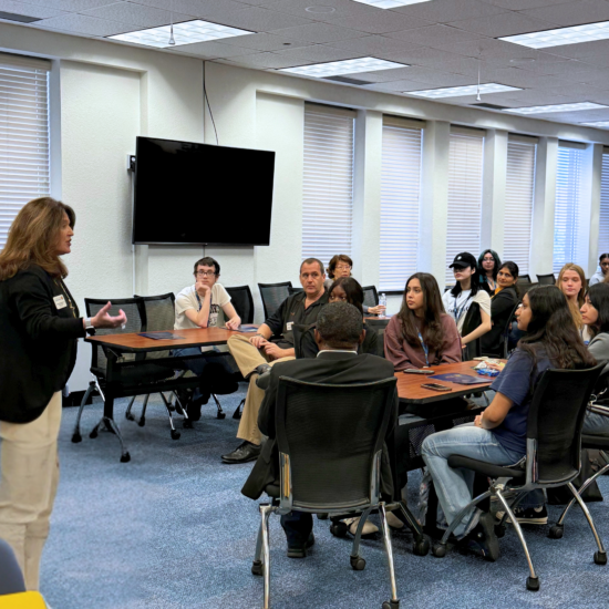 A person speaking to a classroom of people